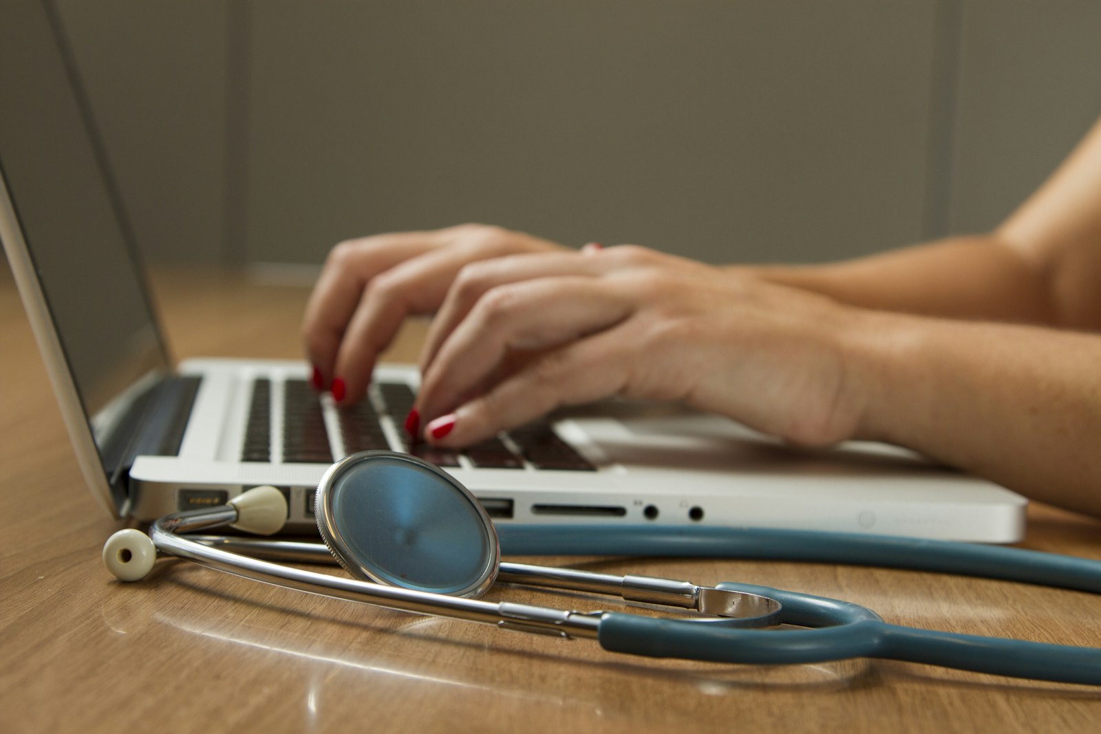 Stethoscope beside a laptop used for clinical records