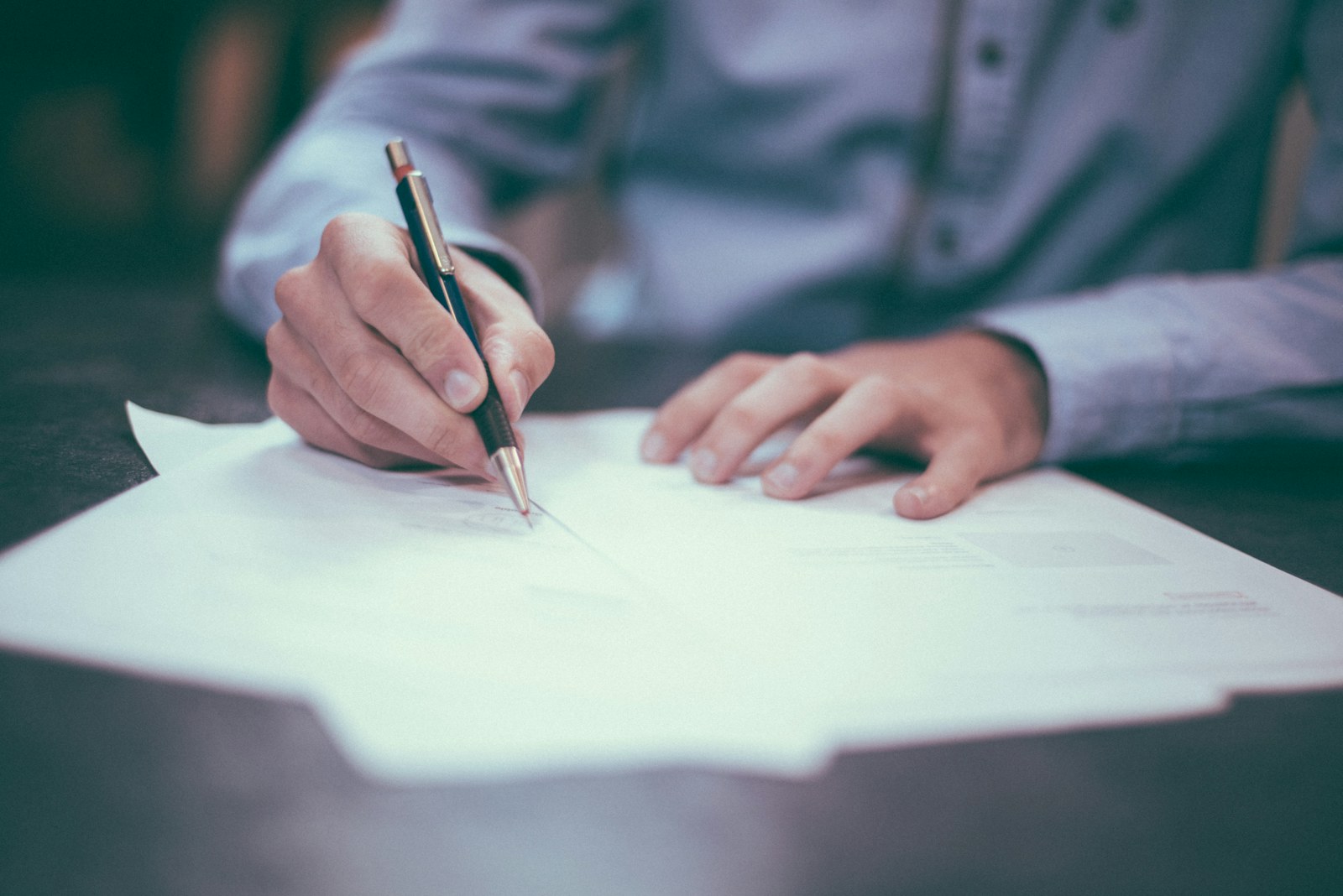 Medical expert witness register — A person writing on a document