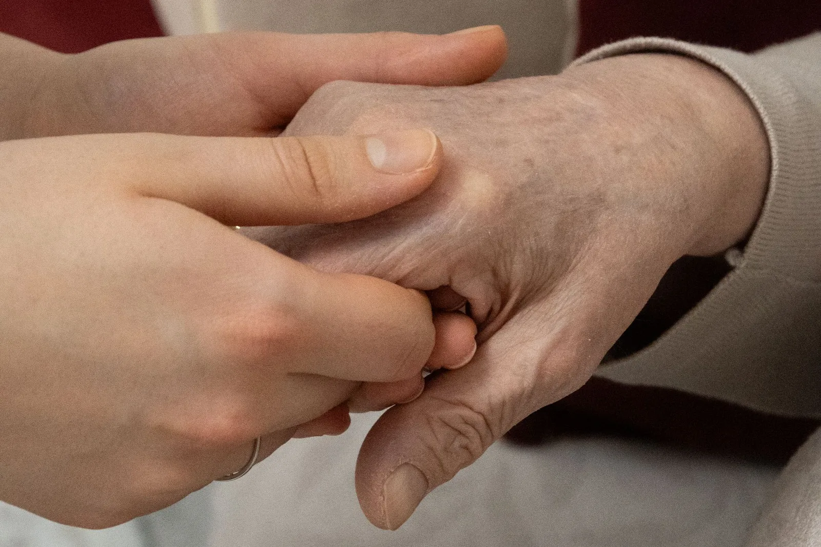Care home negligence expert witness — Carer holding an elderly resident's hands