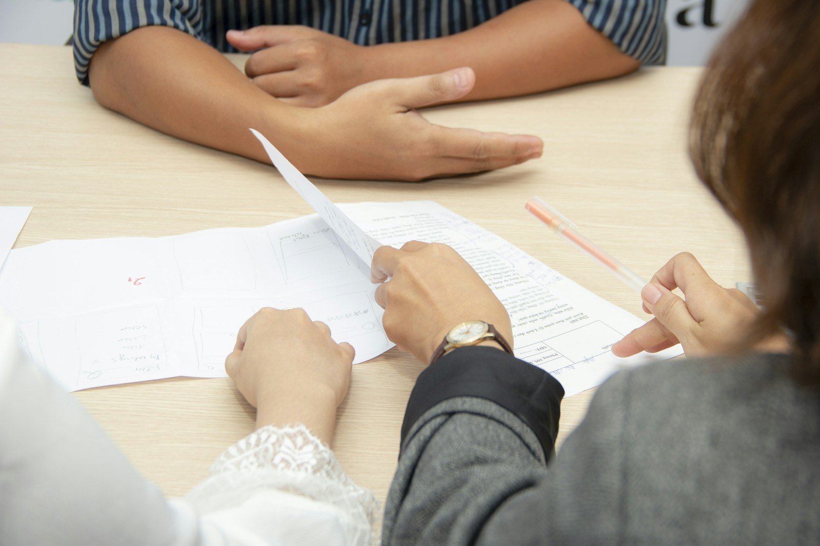 Expert witness claim types — Professionals reviewing case documents at a meeting table