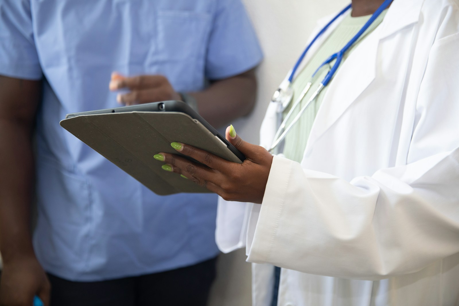 Expert witness report — Two clinicians reviewing patient records, the source material an expert report is built from
