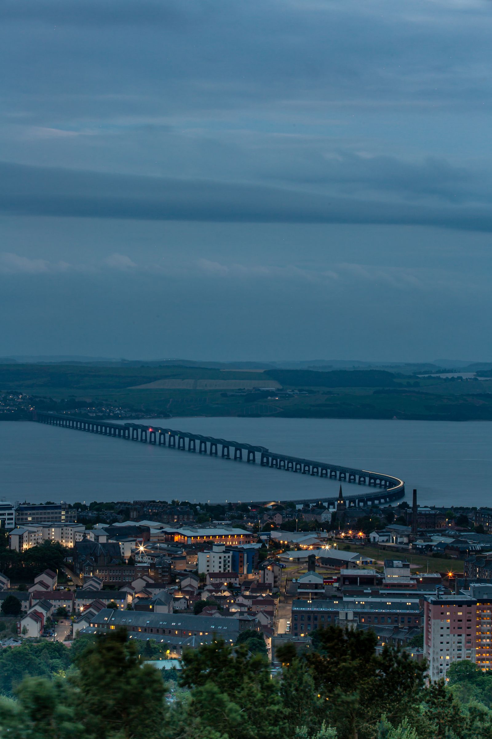 Dundee cityscape and Tay Road Bridge at dusk