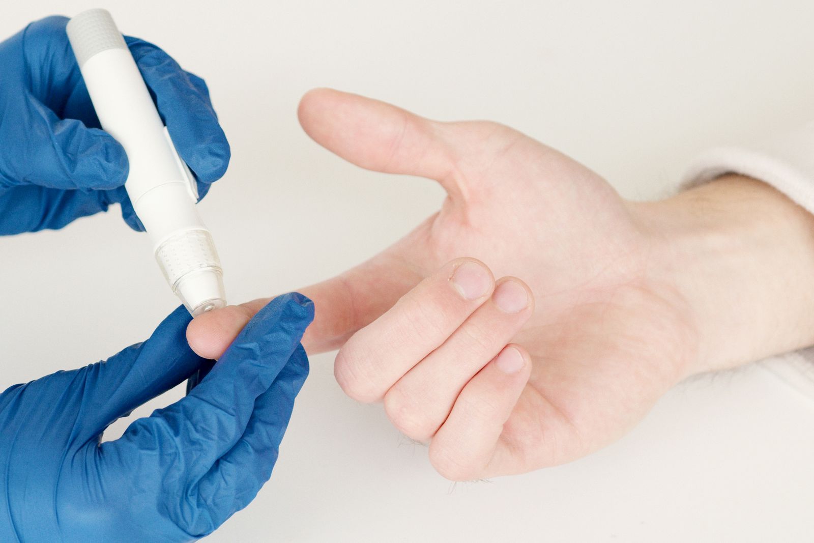 Clinician taking a capillary blood glucose sample, the monitoring diabetes expert witnesses examine