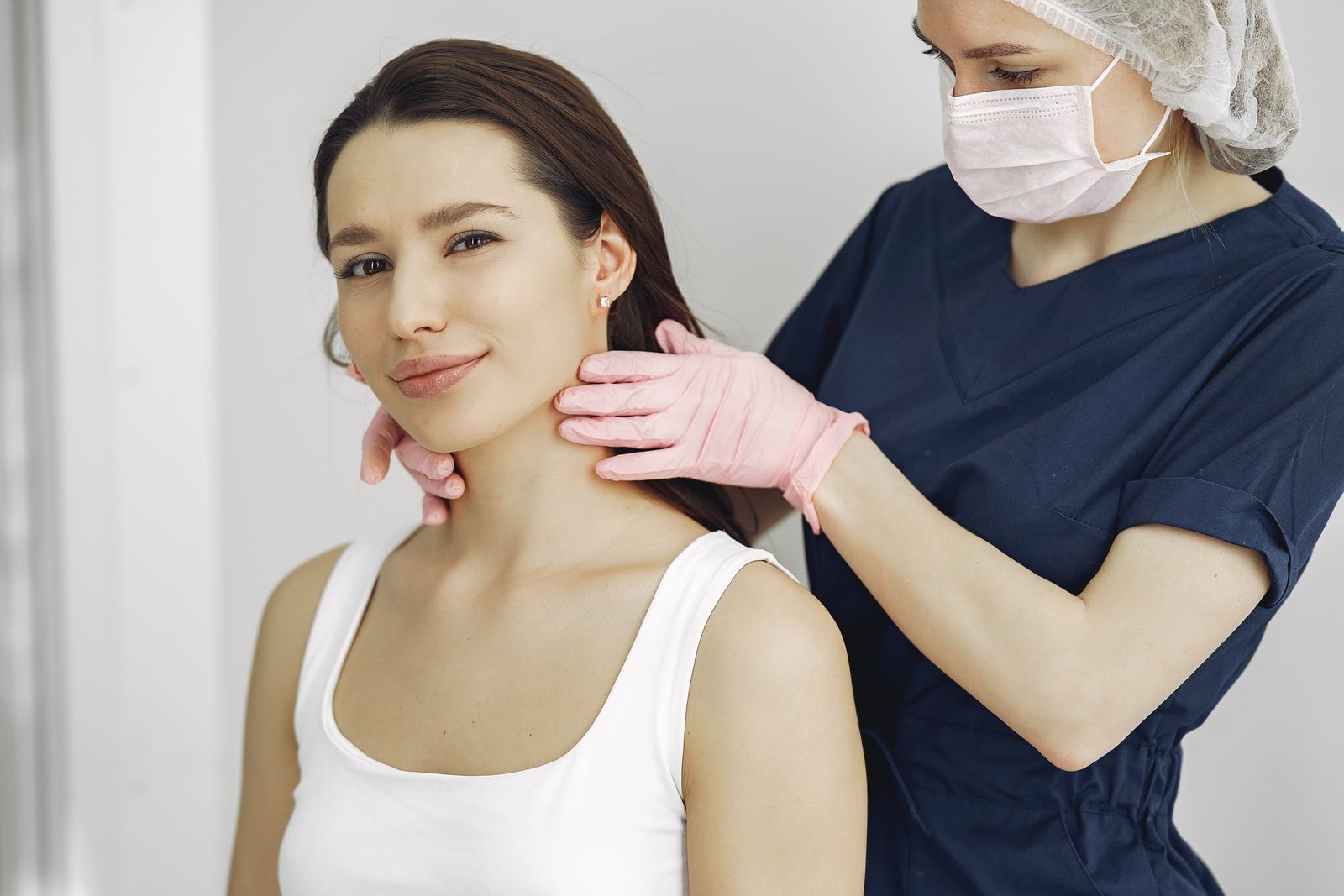 Clinician examining a patient’s neck, the assessment endocrinology expert witnesses review