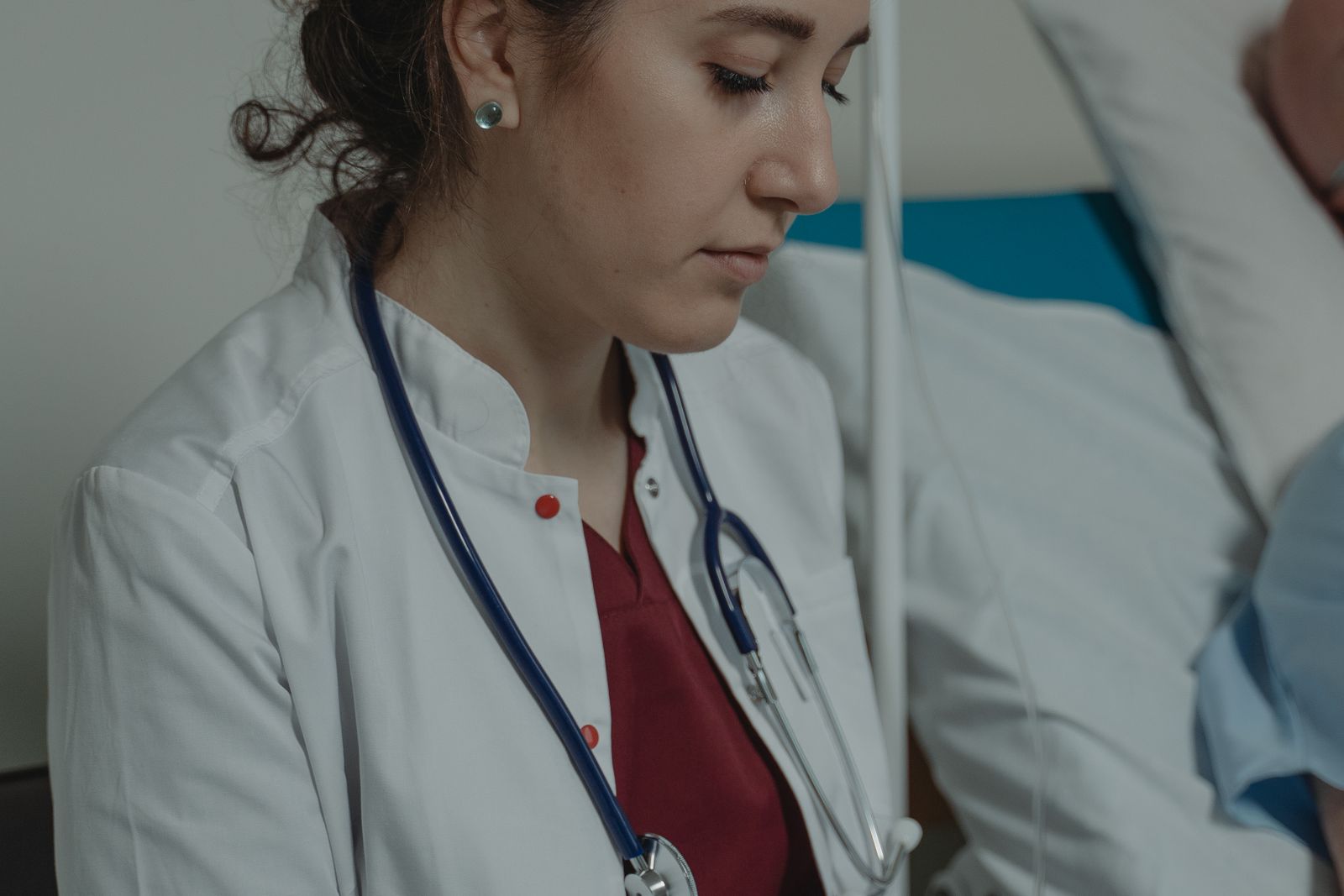 Physician reviewing a patient on a hospital ward, the care general medicine expert witnesses assess