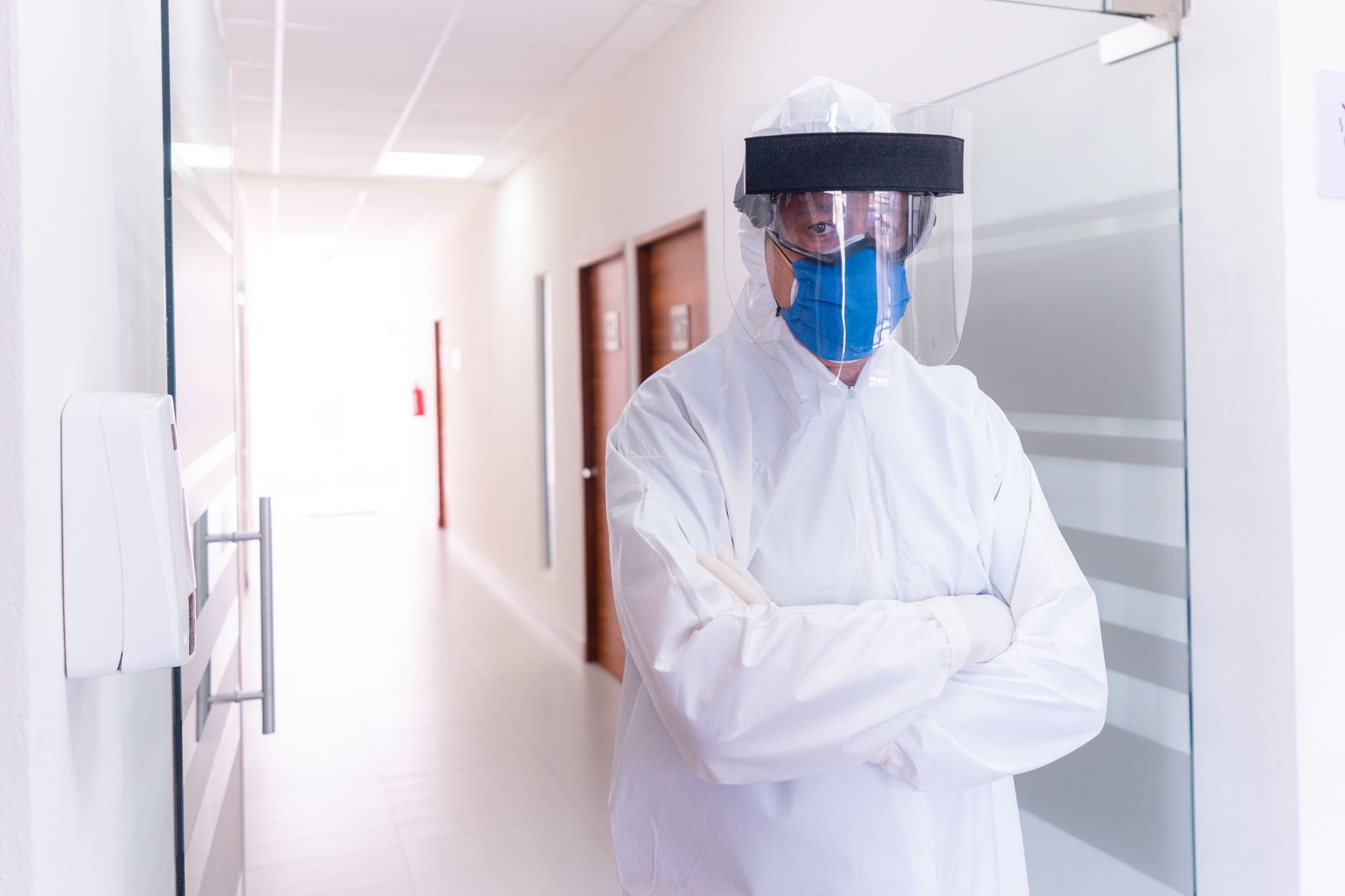 Clinician in protective equipment on a hospital corridor, the practice infectious diseases expert witnesses address
