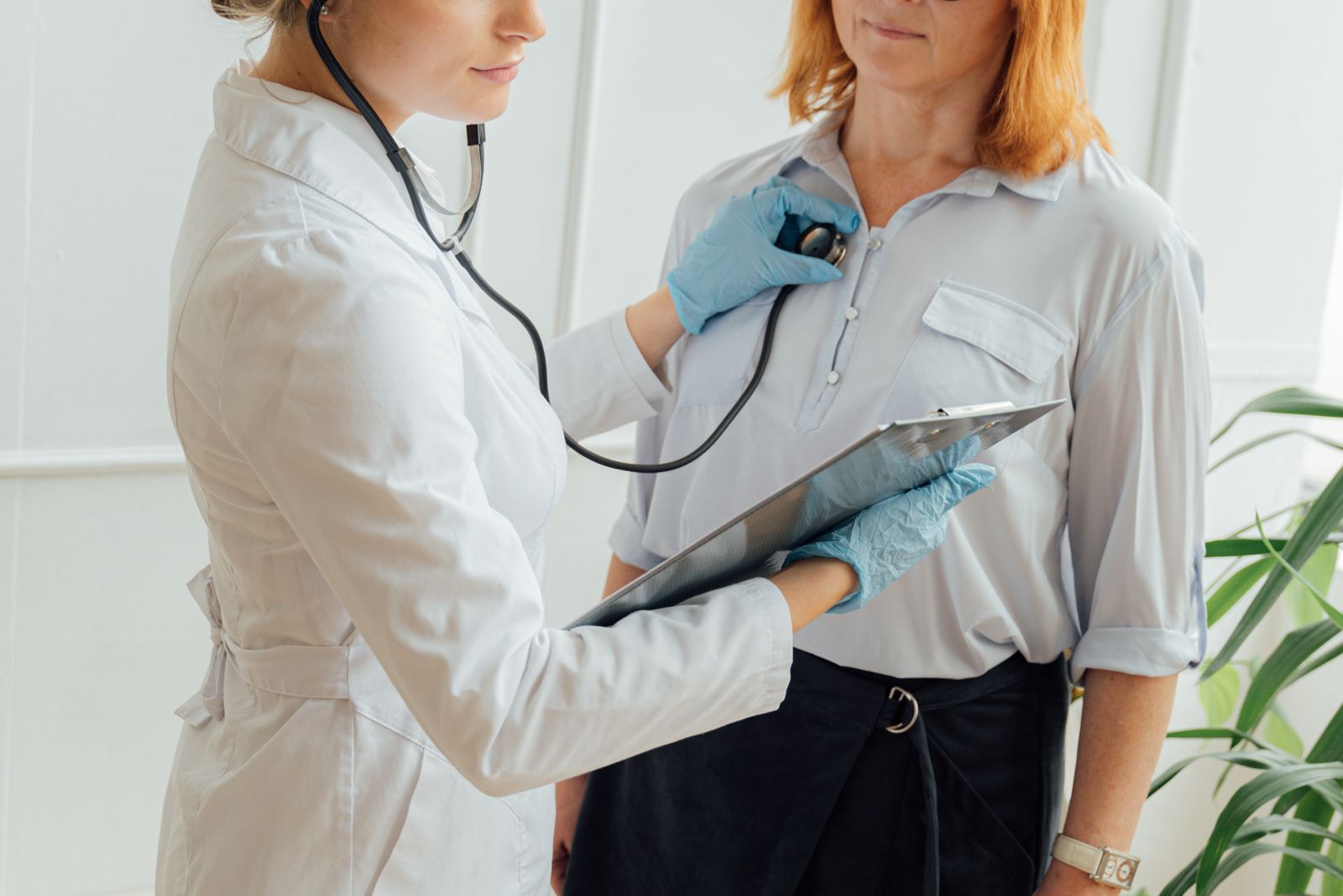 Clinician examining a patient in an outpatient clinic, the care menopause expert witnesses assess