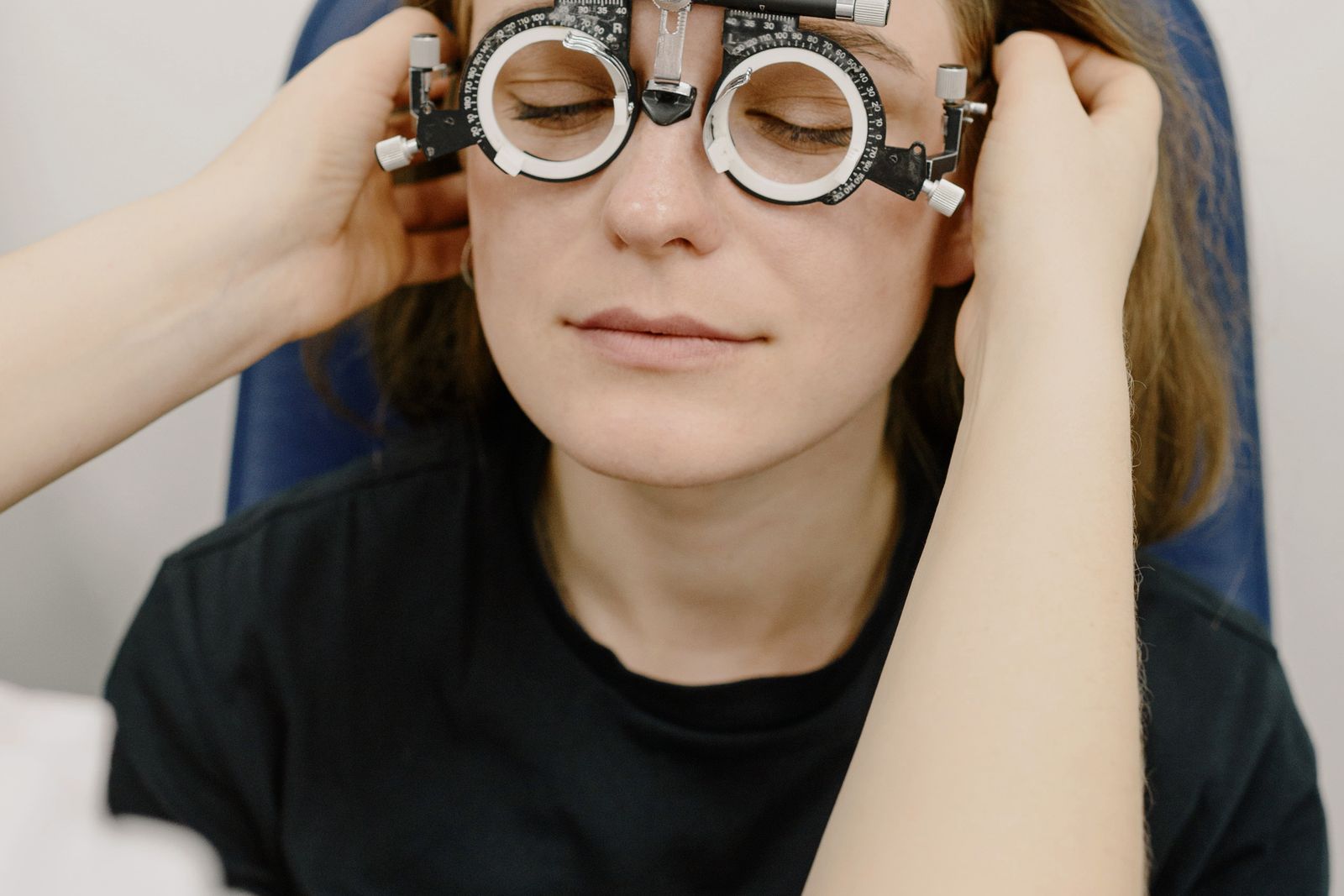 Patient undergoing refraction with a trial frame, the assessment neuro-ophthalmology expert witnesses review