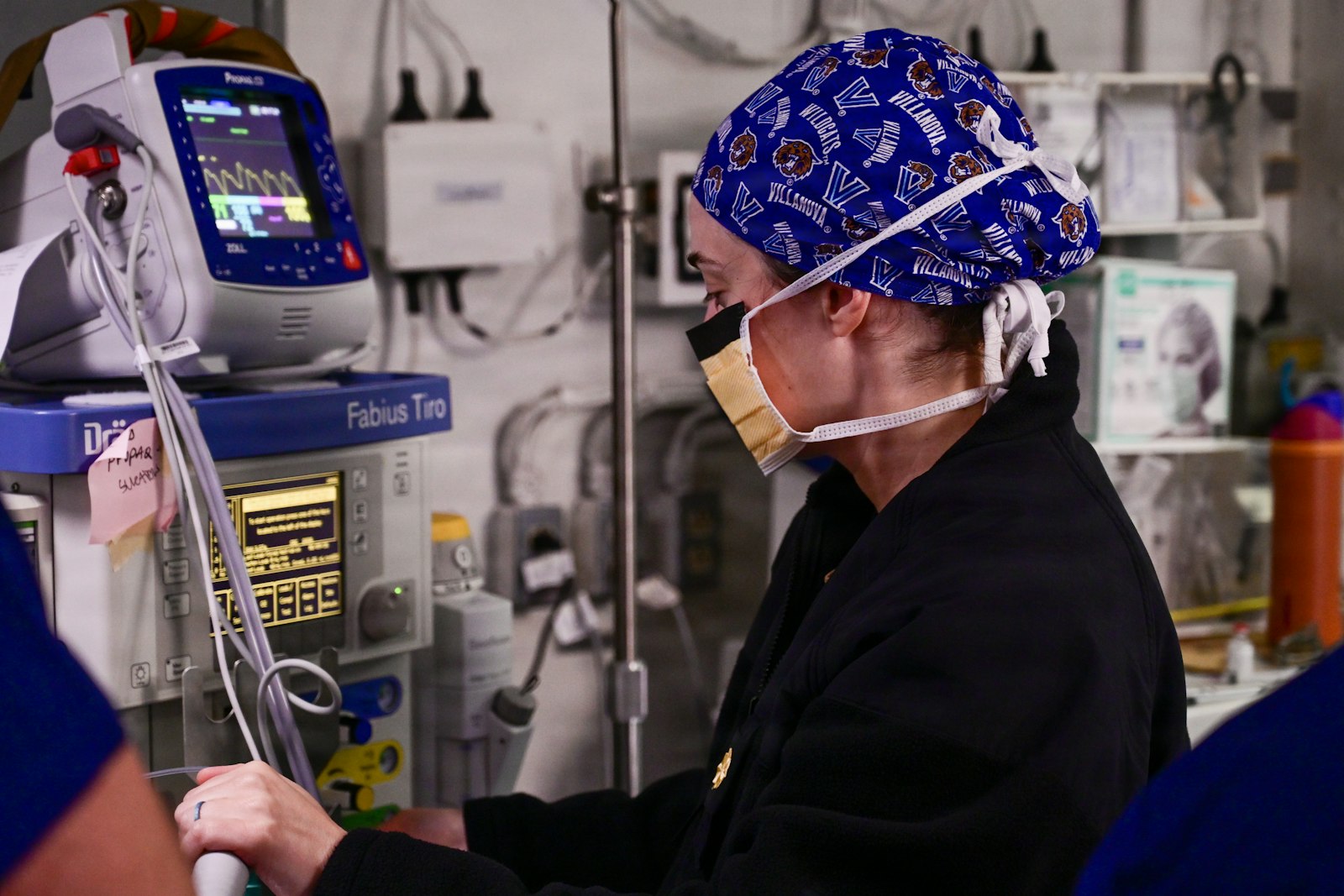 Anaesthetist working at an anaesthetic machine and monitor, the practice anaesthetics expert witnesses examine