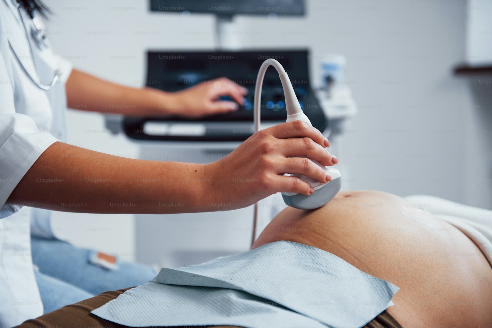 Sonographer carrying out an obstetric ultrasound, the imaging fetal medicine expert witnesses interpret