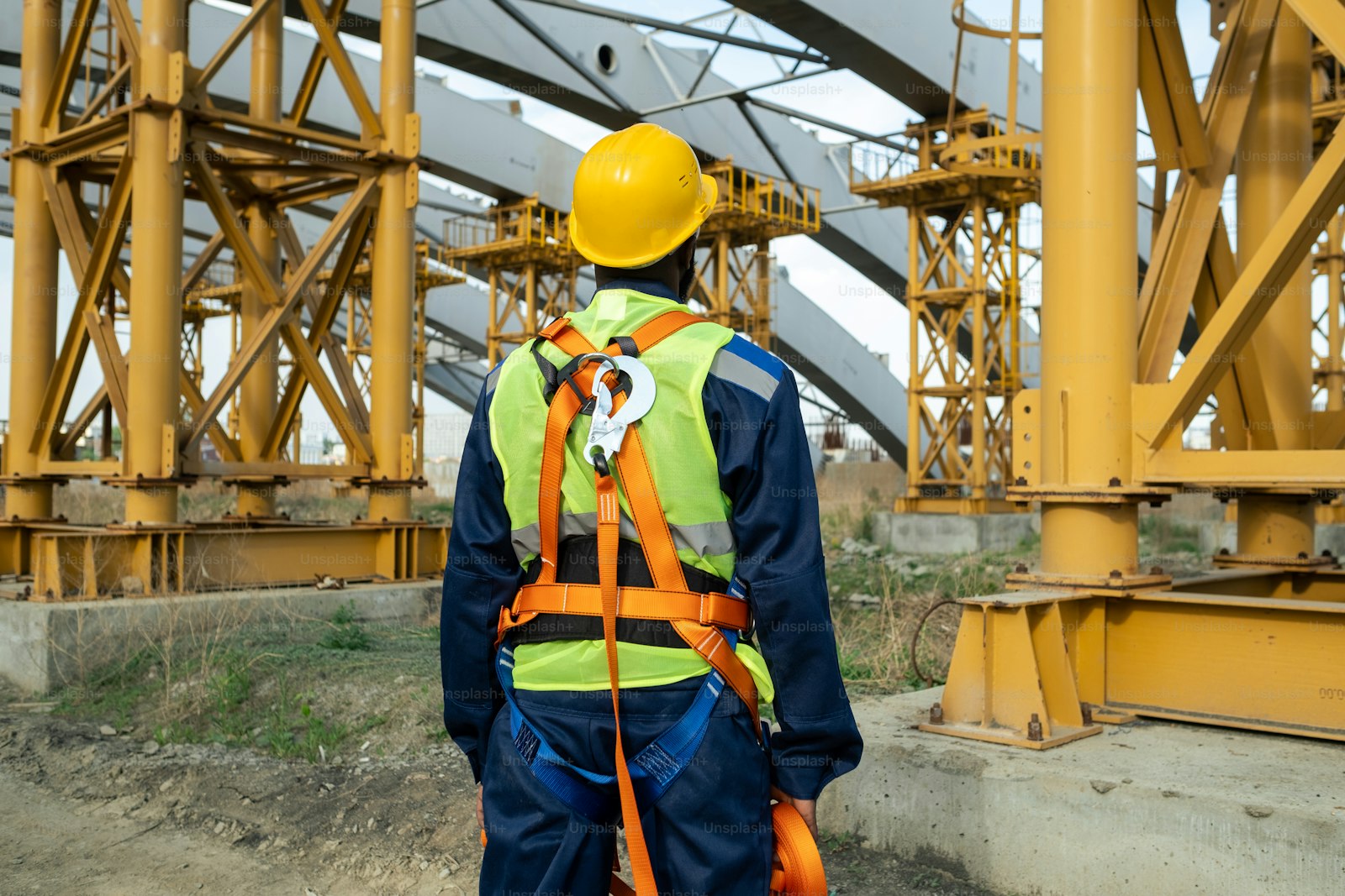 Worker in protective equipment at industrial machinery, the exposure occupational health expert witnesses assess