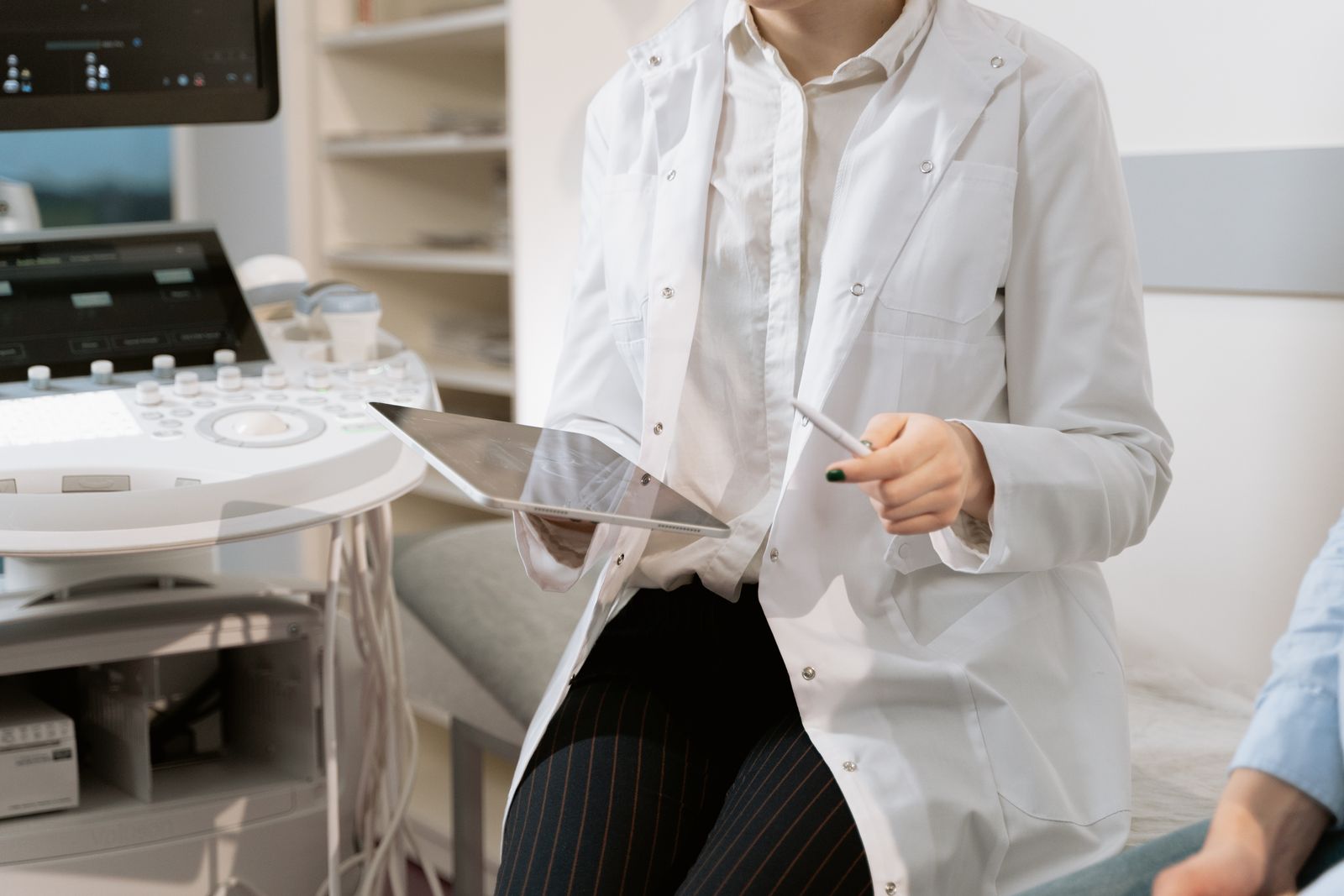 Clinician reviewing breast imaging in a clinic, the evidence breast surgery expert witnesses interpret