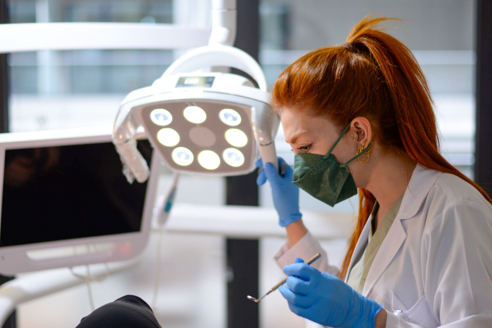 Dentist working under a treatment light, the care dentistry expert witnesses give evidence about