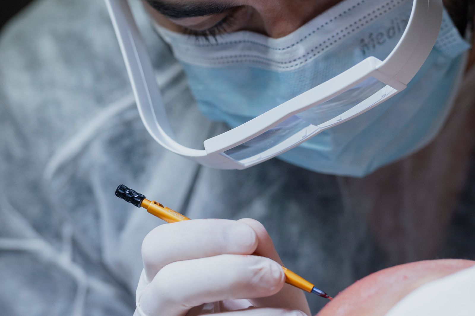 Surgeon operating with magnification and fine instruments, the practice neurosurgery expert witnesses examine