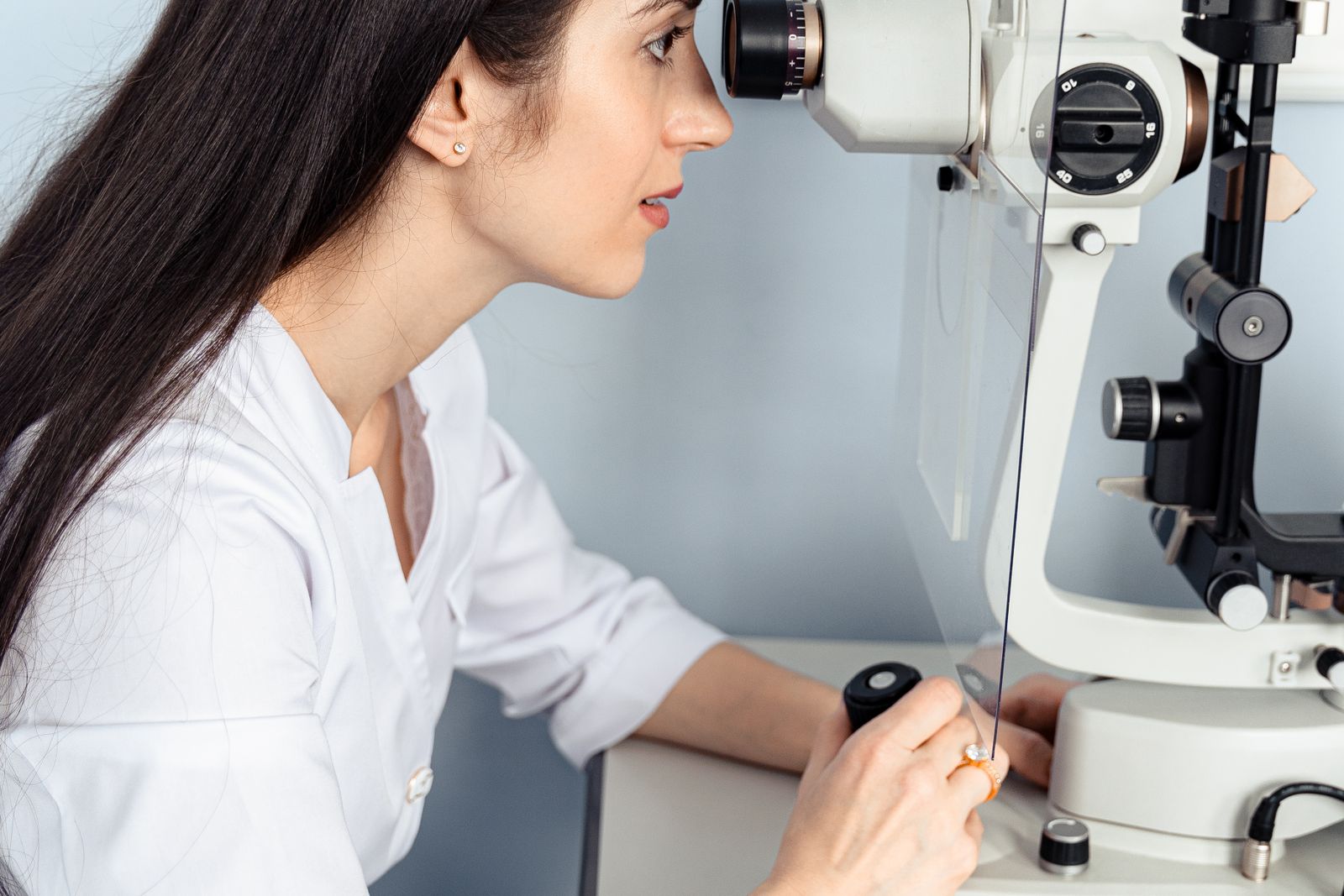 Ophthalmologist examining a patient at a slit lamp, the assessment ophthalmology expert witnesses undertake