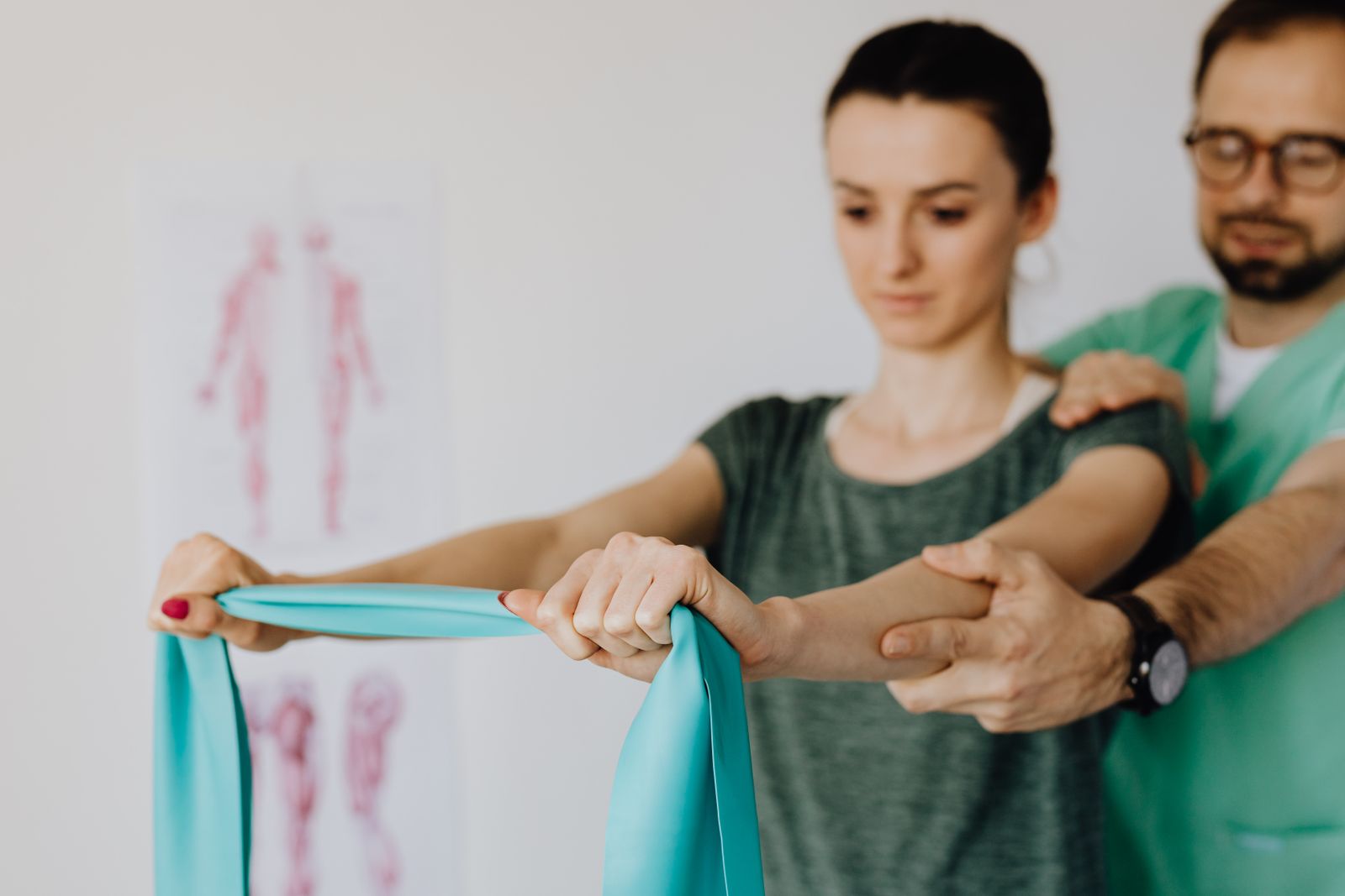 Clinician assessing shoulder movement with a patient, the examination shoulder and elbow surgery expert witnesses undertake