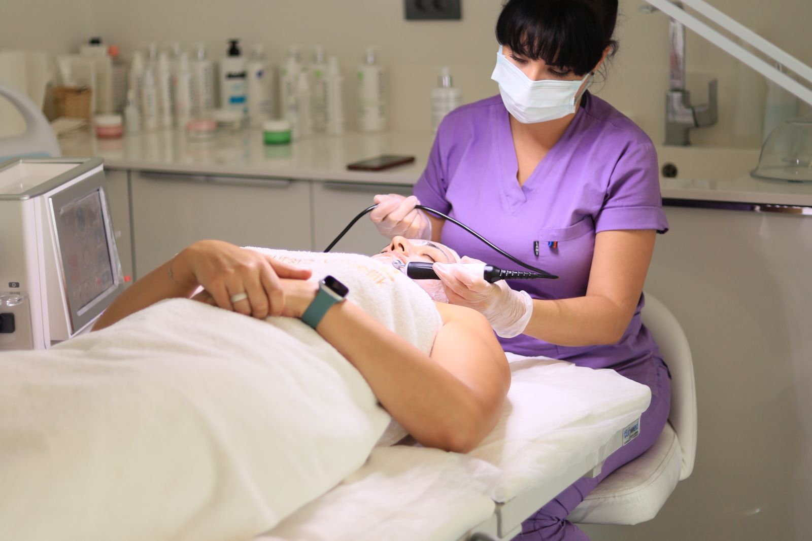 Skin therapist carrying out a facial treatment in a clinic, the practice skin therapy expert witnesses assess