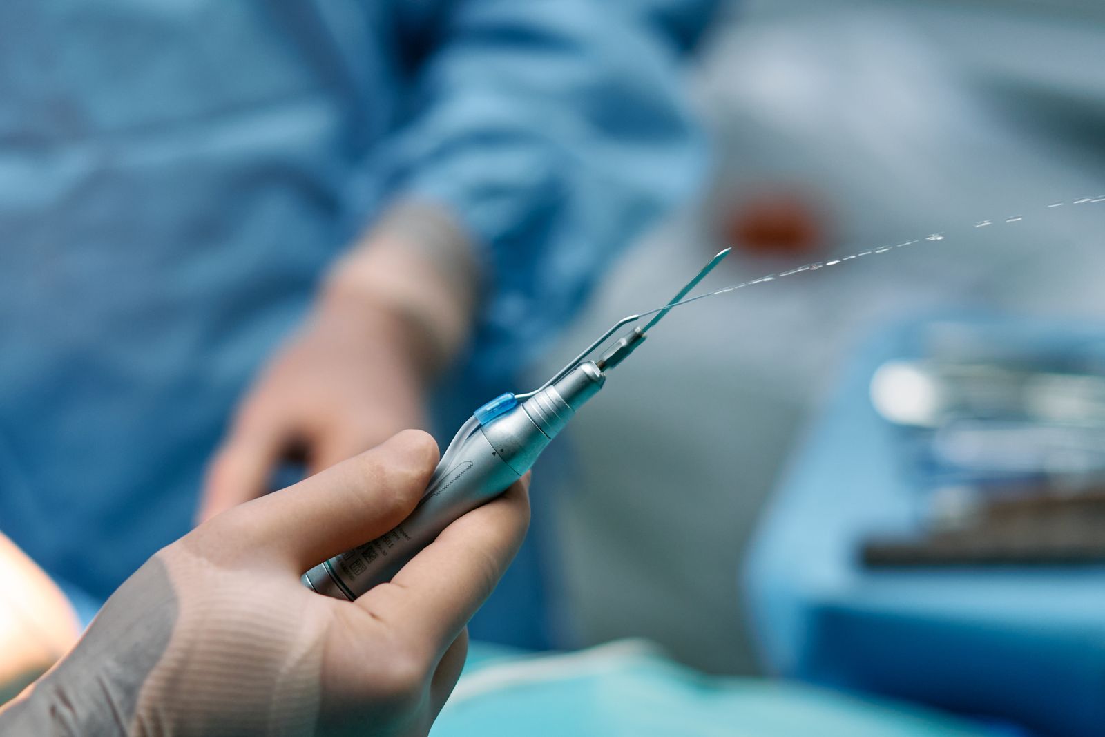 Gloved hands preparing a catheter for a vascular procedure, the practice vascular surgery expert witnesses examine